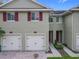 Close-up of the exterior of the townhome showcasing the garage and entry door at 10746 Regent Square Dr # 1502, Orlando, FL 32825