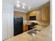 The kitchen features stainless steel appliances, wooden cabinets, and light countertops at 10746 Regent Square Dr # 1502, Orlando, FL 32825
