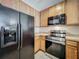 The kitchen features stainless steel appliances, wooden cabinets, and light countertops at 10746 Regent Square Dr # 1502, Orlando, FL 32825