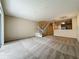 Open living room features new carpet and a staircase to the second floor next to the kitchen at 10746 Regent Square Dr # 1502, Orlando, FL 32825