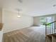 An open living room features new carpet, large slider doors, and a staircase to the second floor at 10746 Regent Square Dr # 1502, Orlando, FL 32825