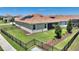 Fenced backyard featuring green lawn and solar panels on the roof at 1101 Downswing Pl, Davenport, FL 33896