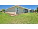 Spacious backyard with a well-maintained lawn, partial fencing, and a covered lanai at 1101 Downswing Pl, Davenport, FL 33896