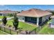 Backyard featuring a well-kept lawn, privacy fence, and a screened-in lanai at 1101 Downswing Pl, Davenport, FL 33896