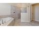 Bathroom featuring a soaking tub, tiled shower, and tile floors at 1101 Downswing Pl, Davenport, FL 33896