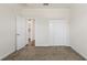 Cozy bedroom with carpet, a double closet, and an open doorway at 1101 Downswing Pl, Davenport, FL 33896