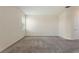 Spacious bedroom with plush carpet, a window with blinds, and a neutral color scheme at 1101 Downswing Pl, Davenport, FL 33896