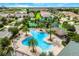 Community pool area with palm trees, lounge chairs, and a tiki hut providing a relaxing resort-style experience at 1101 Downswing Pl, Davenport, FL 33896