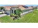 Beautiful home with manicured lawn, stone accents, and solar panels on the roof at 1101 Downswing Pl, Davenport, FL 33896