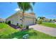 Beautiful one-story home featuring a paver driveway, two-car garage, and lush landscaping at 1101 Downswing Pl, Davenport, FL 33896