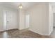 Bright foyer with wood-look tile flooring and a view of the front door at 1101 Downswing Pl, Davenport, FL 33896