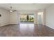 Living room with wood-look flooring and a large sliding glass door to the patio at 1101 Downswing Pl, Davenport, FL 33896