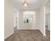 Open-concept living space with wood-look tile flooring and an archway to the dining area at 1101 Downswing Pl, Davenport, FL 33896