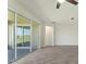 Bright living room featuring sliding glass doors and wood-look tile flooring at 1101 Downswing Pl, Davenport, FL 33896