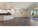 Open-concept living space featuring a modern kitchen, ceiling fan, and wood-look floors at 1101 Downswing Pl, Davenport, FL 33896