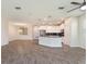 Open-concept living space with modern kitchen, pendant lighting, and wood-look flooring at 1101 Downswing Pl, Davenport, FL 33896