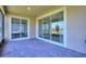 Spacious outdoor patio with brick pavers and sliding glass doors, perfect for entertaining at 1101 Downswing Pl, Davenport, FL 33896