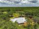 Aerial view of house surrounded by trees and natural Florida landscape at 11323 Kijik Trl, Groveland, FL 34736