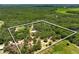 Aerial view of land and house with property boundary line at 11323 Kijik Trl, Groveland, FL 34736