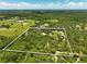 Expansive aerial view of the homesite surrounded by lush greenery and open land at 11323 Kijik Trl, Groveland, FL 34736