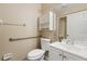 Bathroom with grab bar, mirrored vanity, and overhead storage space at 11323 Kijik Trl, Groveland, FL 34736
