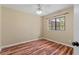 Bedroom features hardwood floors, ceiling fan, and natural light from a large window at 11323 Kijik Trl, Groveland, FL 34736