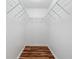 Walk-in closet with wire shelving and hardwood floors at 11323 Kijik Trl, Groveland, FL 34736