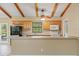 Kitchen featuring wooden cabinets, a breakfast bar, appliances, and easy access to the outdoors at 11323 Kijik Trl, Groveland, FL 34736