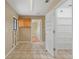 Functional laundry room with cabinets, shelving, and access to additional storage space at 11323 Kijik Trl, Groveland, FL 34736
