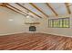 Spacious living room showcasing a stone fireplace, wood flooring, and bright windows offering natural light at 11323 Kijik Trl, Groveland, FL 34736