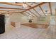 Open-concept living area with exposed beam ceiling, stone fireplace and wood-look floors at 11323 Kijik Trl, Groveland, FL 34736