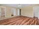 Main bedroom with hardwood floors and adjacent bathroom with a shower and tile flooring at 11323 Kijik Trl, Groveland, FL 34736