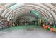 Large outbuilding interior with metal walls, and a variety of storage shelves and items at 11323 Kijik Trl, Groveland, FL 34736