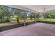 A screened patio with ceiling fan provides ample space for relaxation and enjoying the outdoor views at 11323 Kijik Trl, Groveland, FL 34736