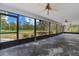 Screened porch with concrete flooring and views of the surrounding landscape at 11323 Kijik Trl, Groveland, FL 34736