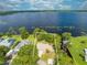 Expansive aerial view of the lakefront home with lush greenery and stunning lake views at 1186 Laguna Cir, St Cloud, FL 34771