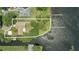 Aerial view of the lakefront property with dock and well-maintained lawn at 1186 Laguna Cir, St Cloud, FL 34771