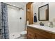 Bathroom with shower and tub, granite countertop, and wood cabinets at 1186 Laguna Cir, St Cloud, FL 34771