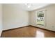 Bedroom with hardwood flooring, ceiling fan, and backyard views at 1186 Laguna Cir, St Cloud, FL 34771