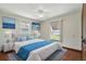Bedroom with hardwood flooring, ceiling fan, and views of the lake at 1186 Laguna Cir, St Cloud, FL 34771