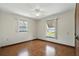 Bedroom with hardwood flooring, ceiling fan, and lake views at 1186 Laguna Cir, St Cloud, FL 34771