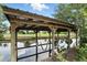 Covered boat dock on the water with slings for boat storage and clear water reflection at 1186 Laguna Cir, St Cloud, FL 34771