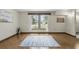 Bright and spacious living room features hardwood floors, neutral paint, and large windows at 1186 Laguna Cir, St Cloud, FL 34771