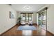 Bright living area with hardwood flooring, a sliding glass door, and scenic outdoor views at 1186 Laguna Cir, St Cloud, FL 34771