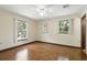 Bright main bedroom featuring hardwood floors and large windows overlooking the yard at 1186 Laguna Cir, St Cloud, FL 34771