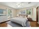 Bright main bedroom featuring hardwood floors, large windows, and modern decor at 1186 Laguna Cir, St Cloud, FL 34771