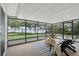 Enclosed porch featuring a lake view, outdoor furniture, and carpeted floors at 1186 Laguna Cir, St Cloud, FL 34771