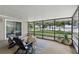 Cozy screened patio with comfortable seating, overlooking a serene lake view at 1186 Laguna Cir, St Cloud, FL 34771