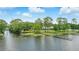 Picturesque waterfront with private docks and landscaped yards along the tranquil lake, under a partly cloudy sky at 1186 Laguna Cir, St Cloud, FL 34771