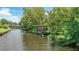 Scenic canal view featuring a covered boat dock amidst lush green vegetation at 1186 Laguna Cir, St Cloud, FL 34771